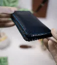 Side profile of blue full-grain vegetable-tanned leather mini long bifold card wallet.webp